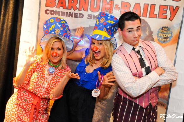 Monumental Sports' LaRhonda Lombardi and Availor Philanthropy's Katherine Kennedy clown around with performer Dustin Portello.